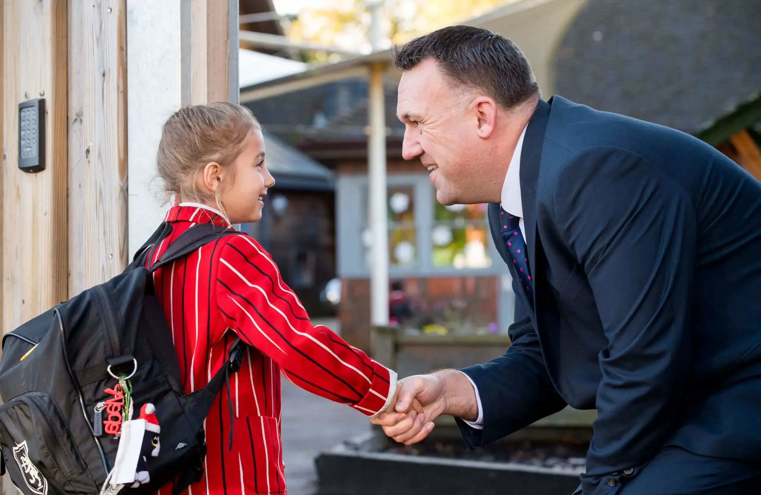 Shrewsbury House Pre-Prep Head greeting a student at the school gate
