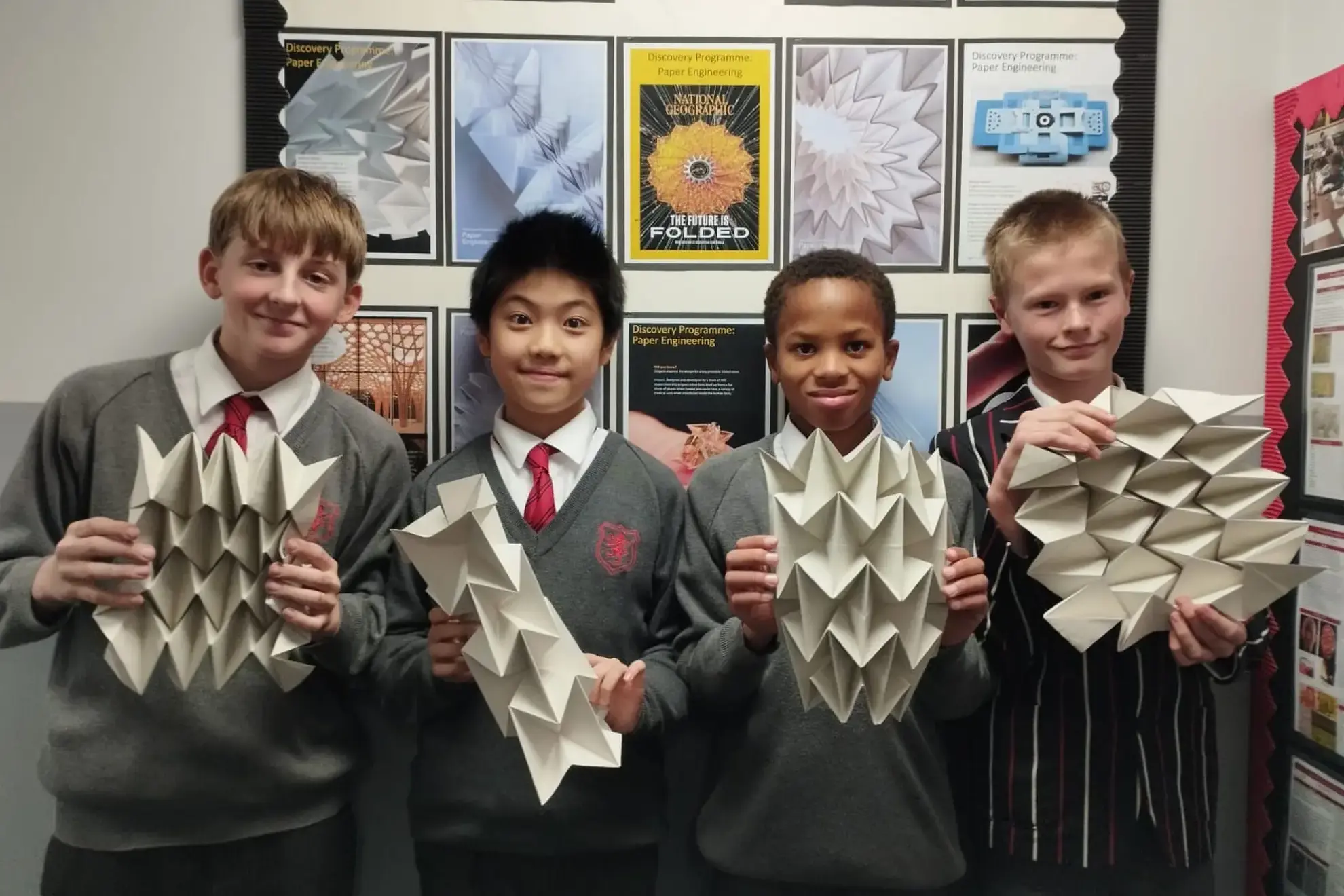 Students showing their paper art