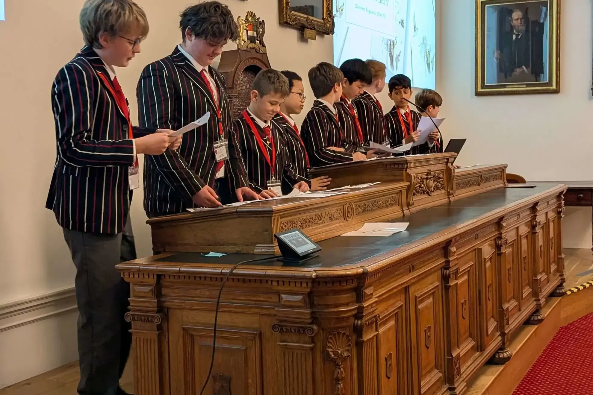 Group of students reading their presentation cards