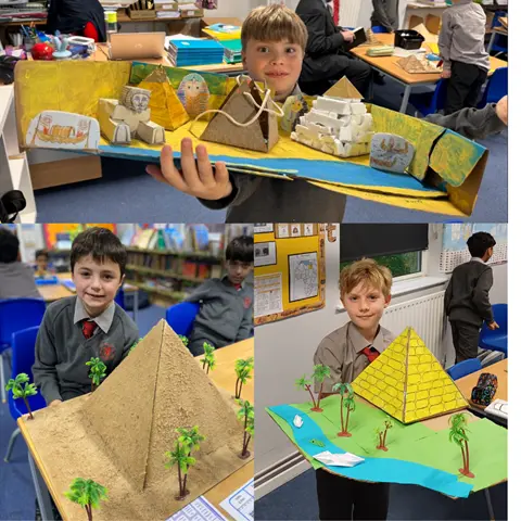 Boys hold up their pyramid artwork