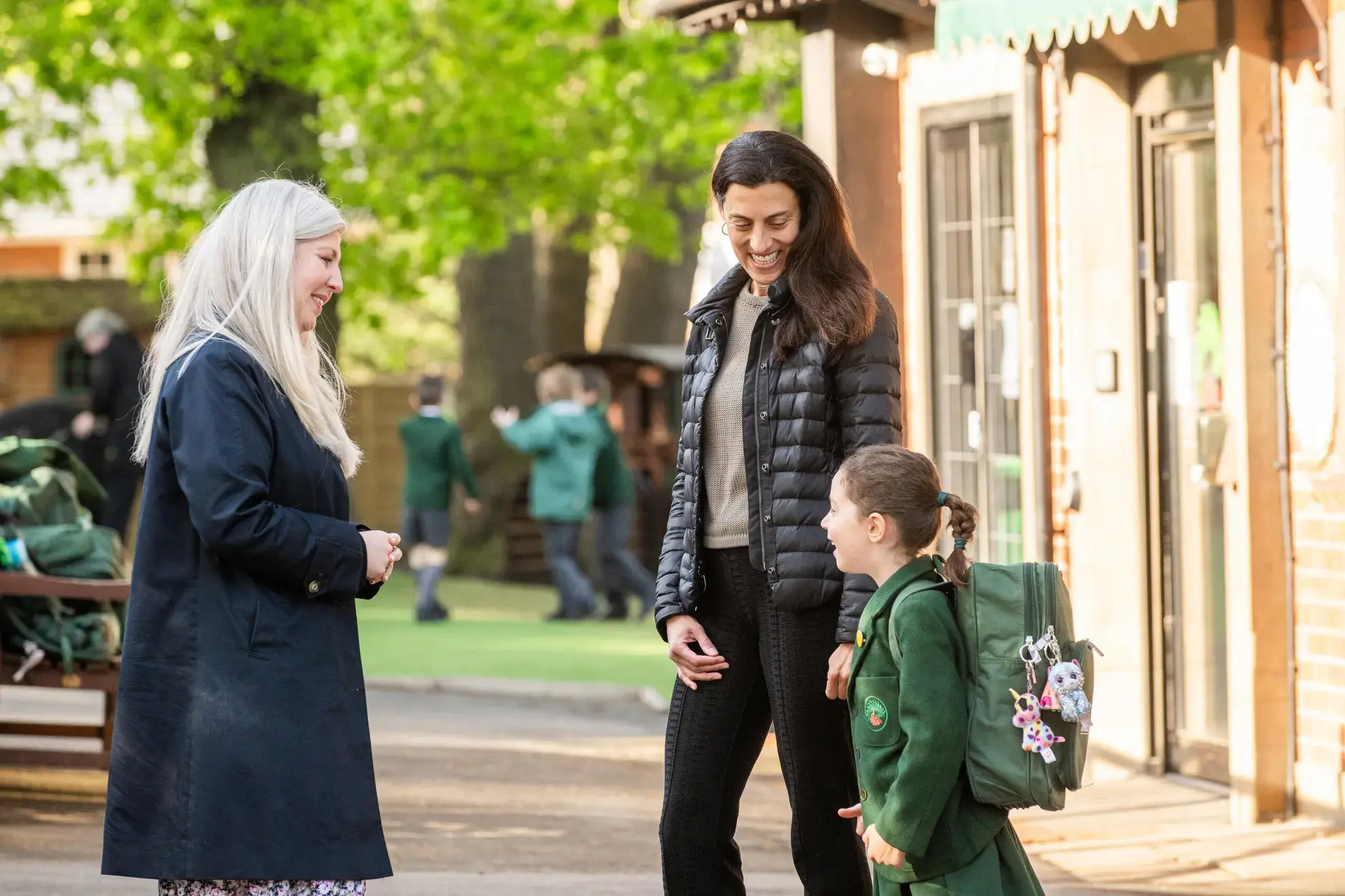 Teacher speaking to parent and pupil