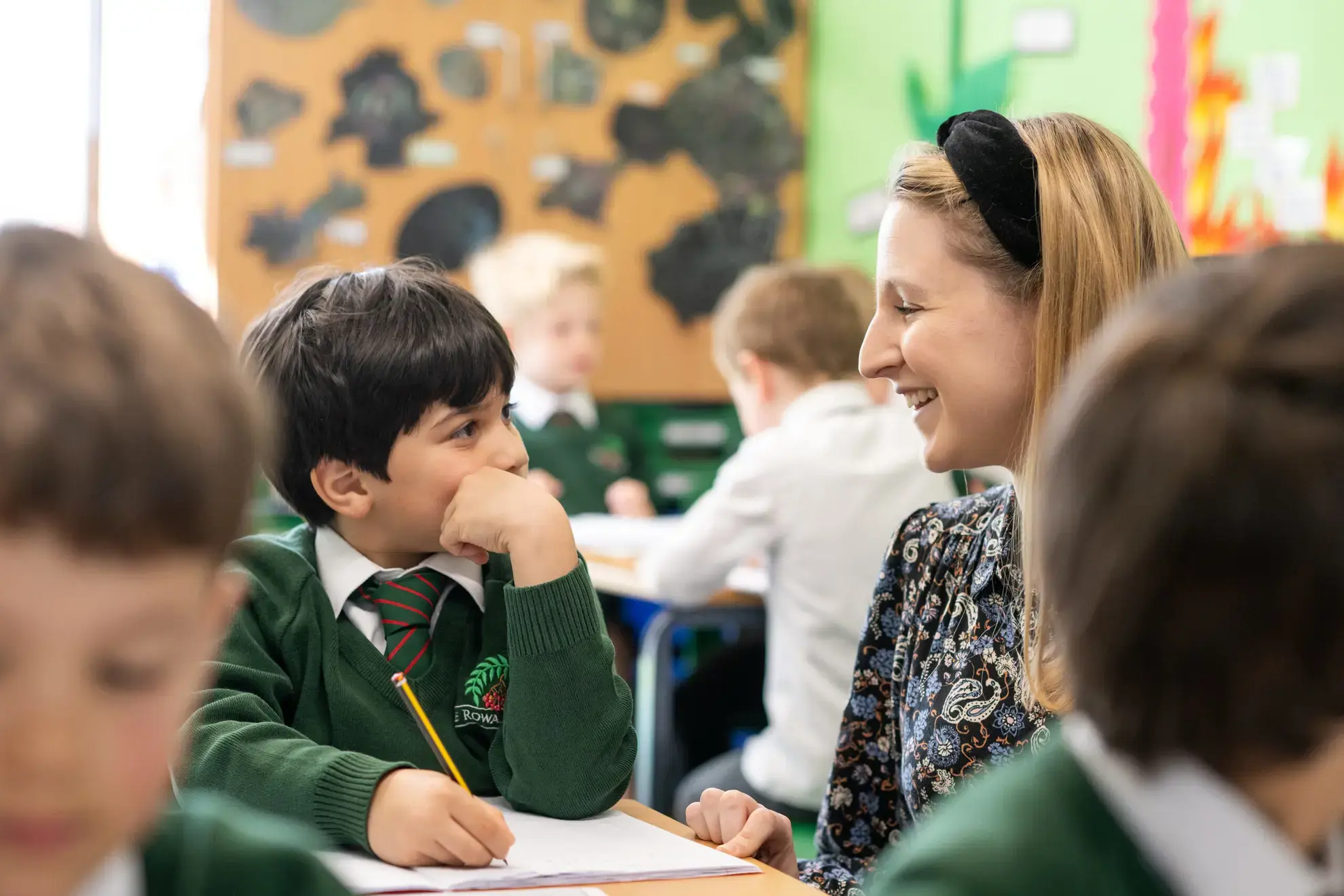 Teacher chatting to student in classroom