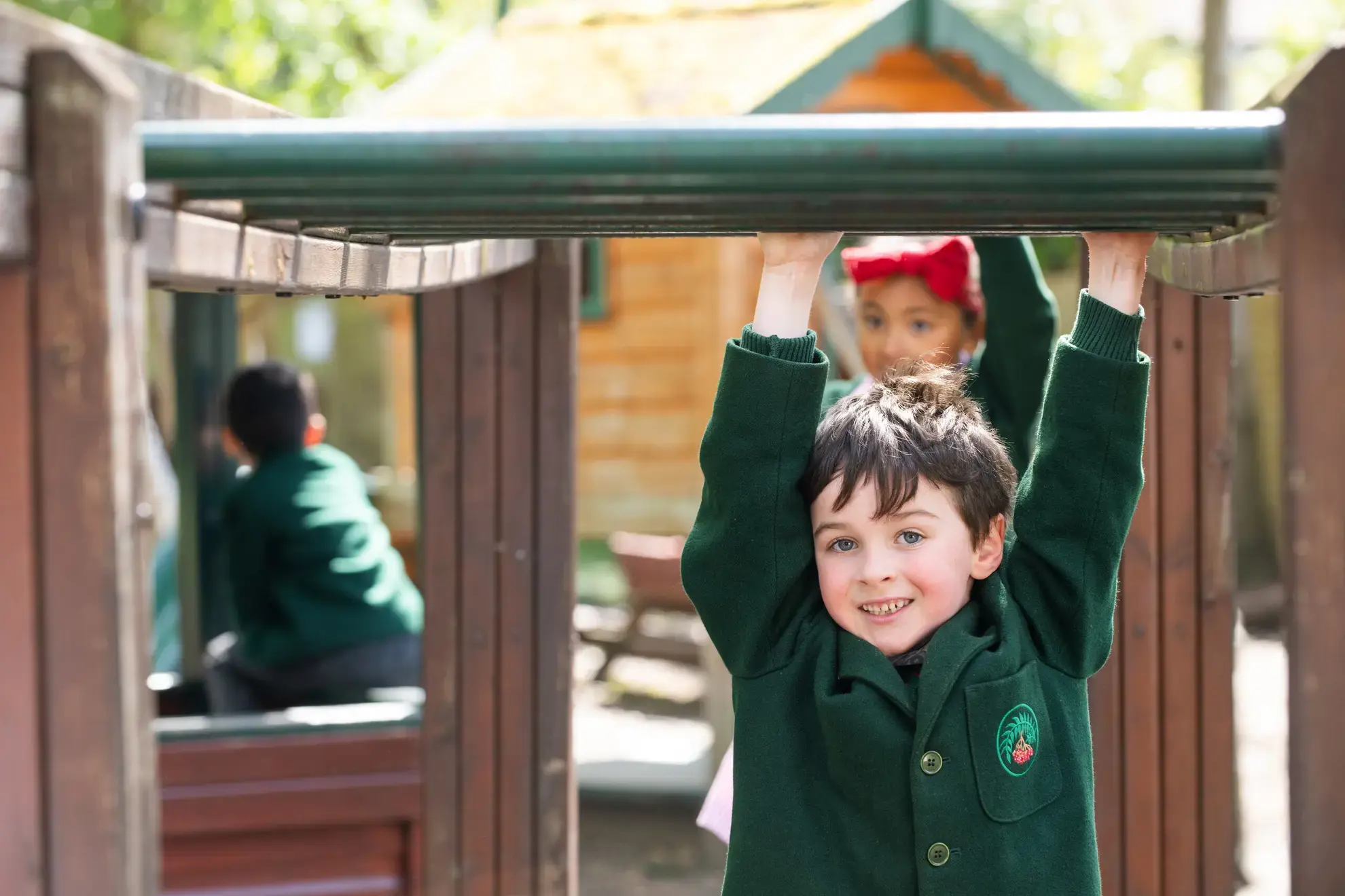 Student hanging from monkey bars