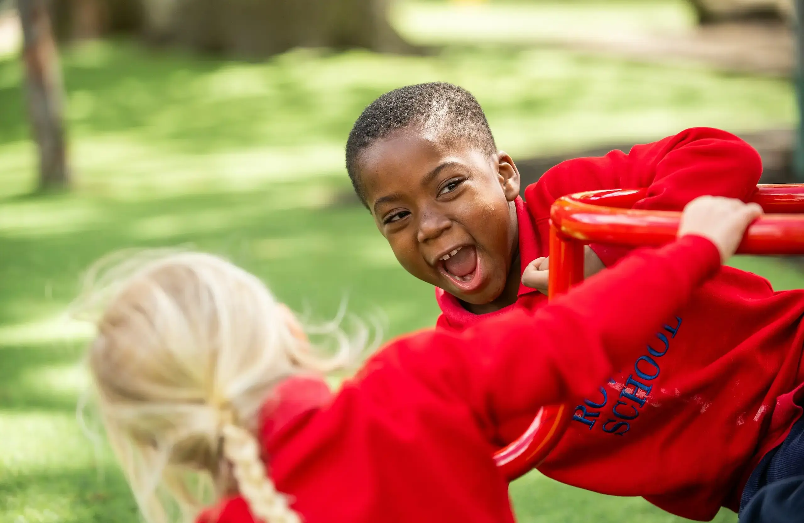 Two children playing on playground equipment