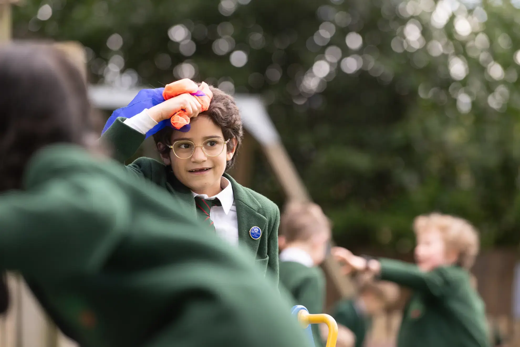Student holding a flag against their head