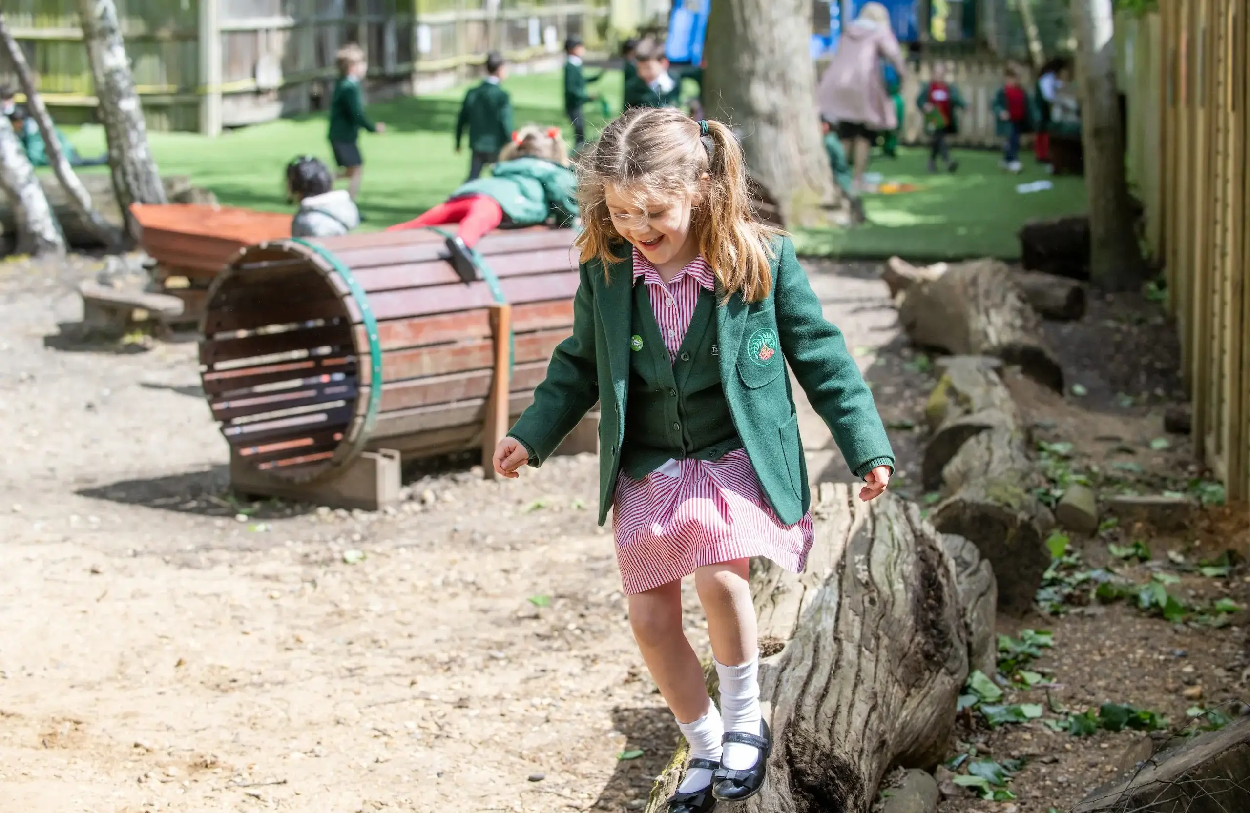 Student playing on a rustic playground area