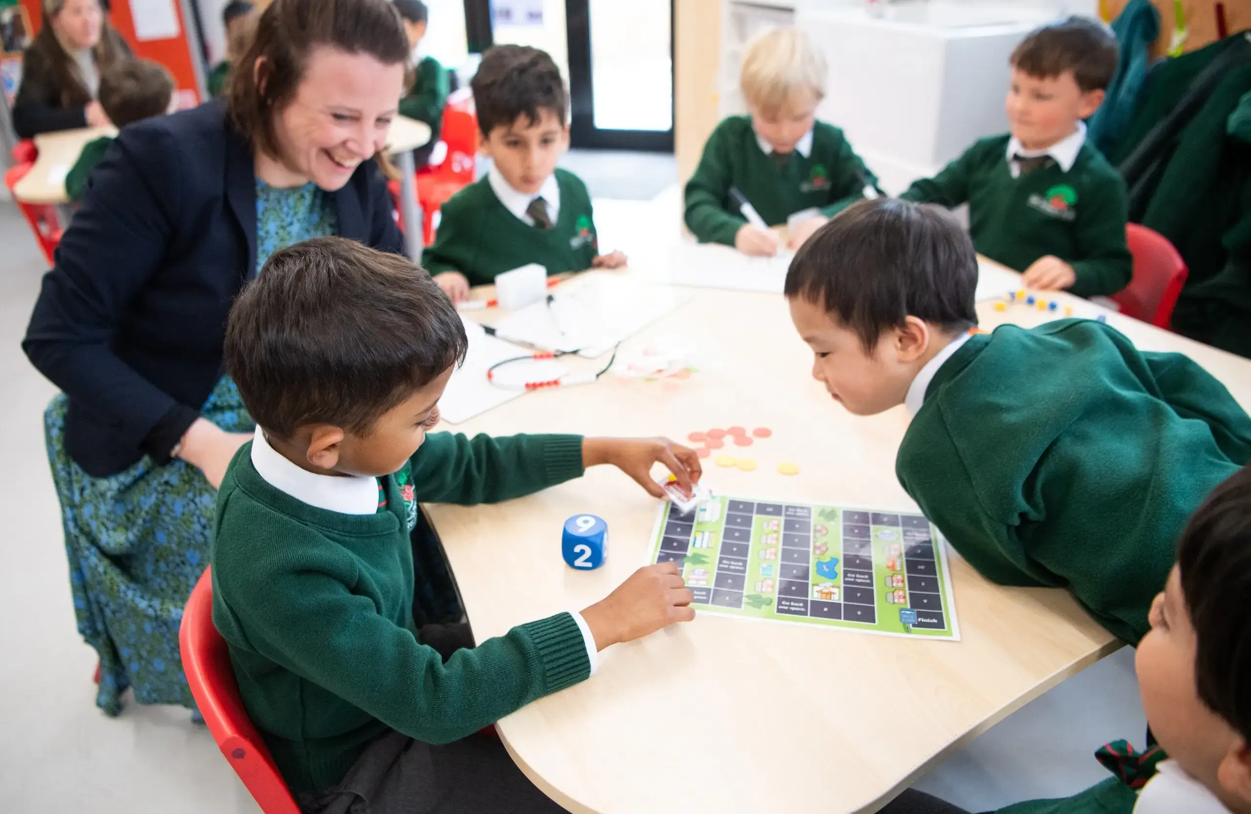 Teacher working with students on some schoolwork in a classroom