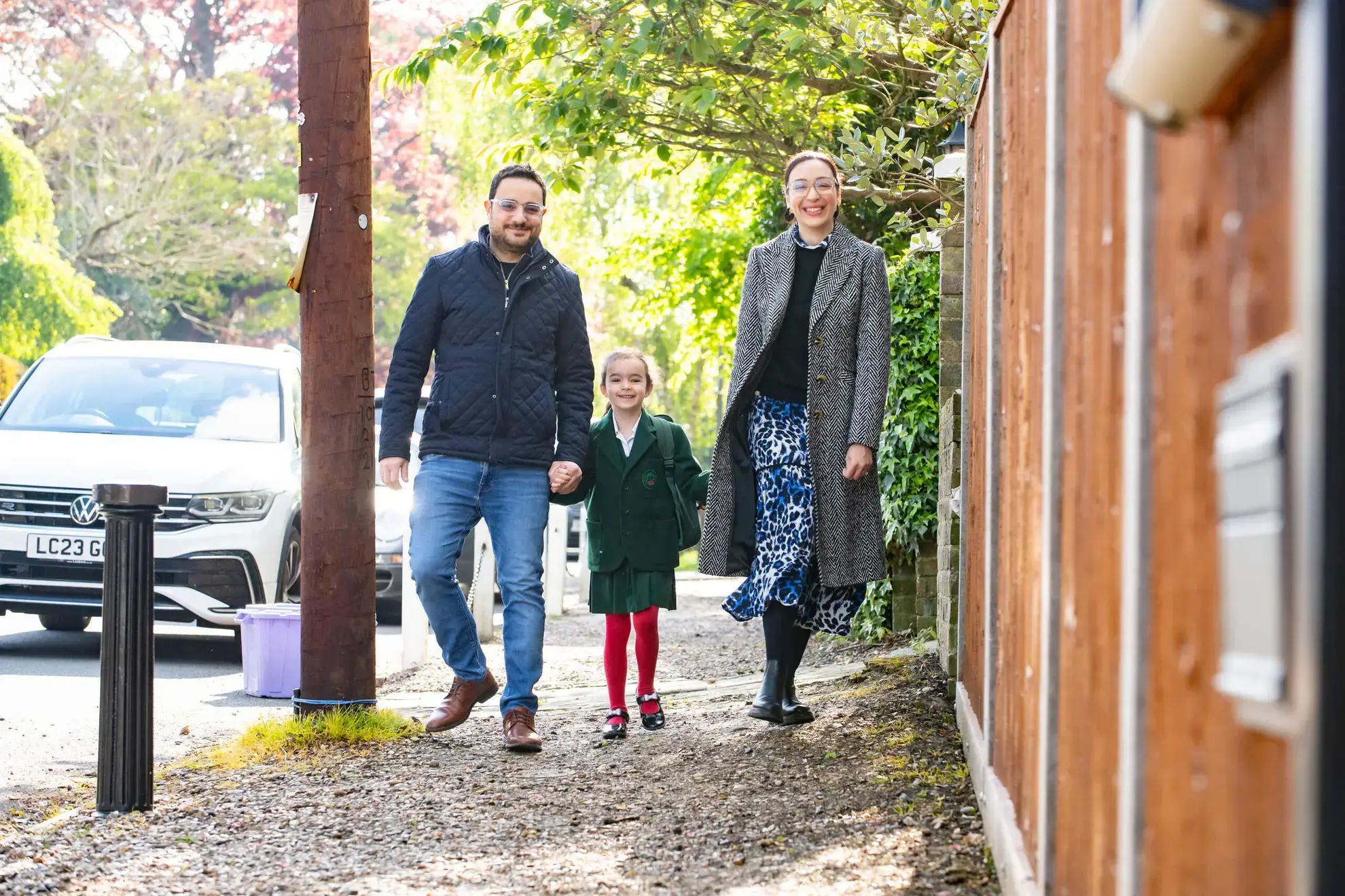 Parents and child walking hand in hand