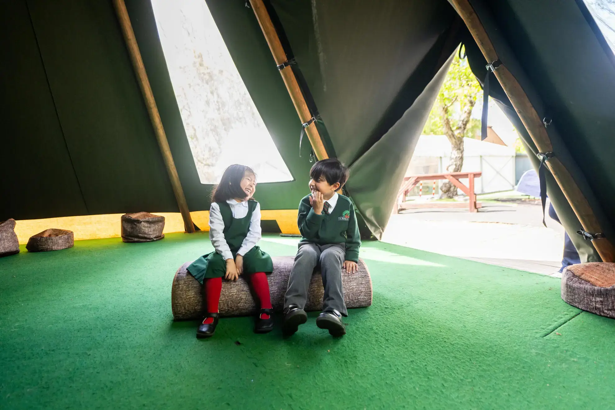 Students smiling in tipi