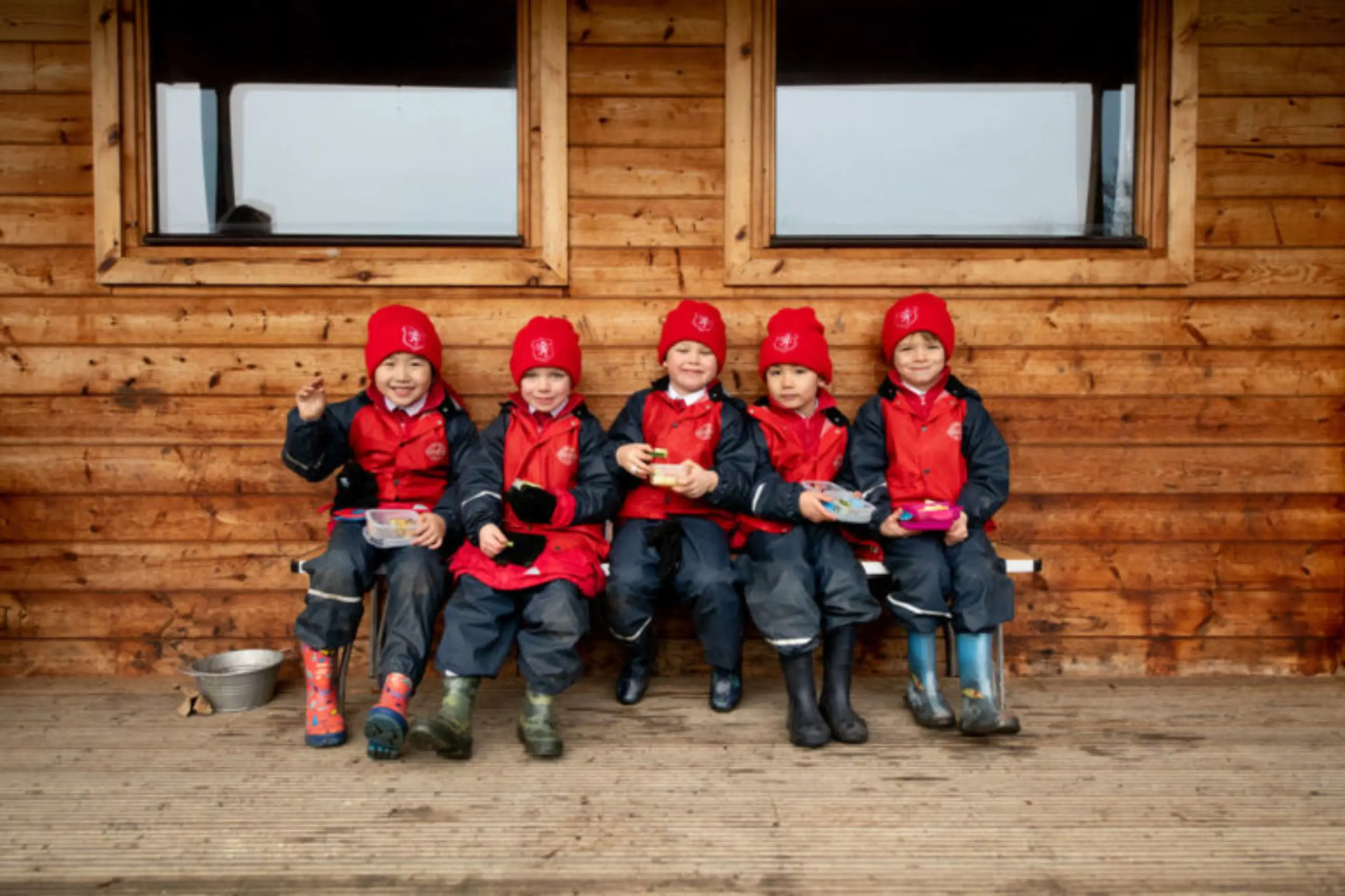Students having snacks outside at the forest school