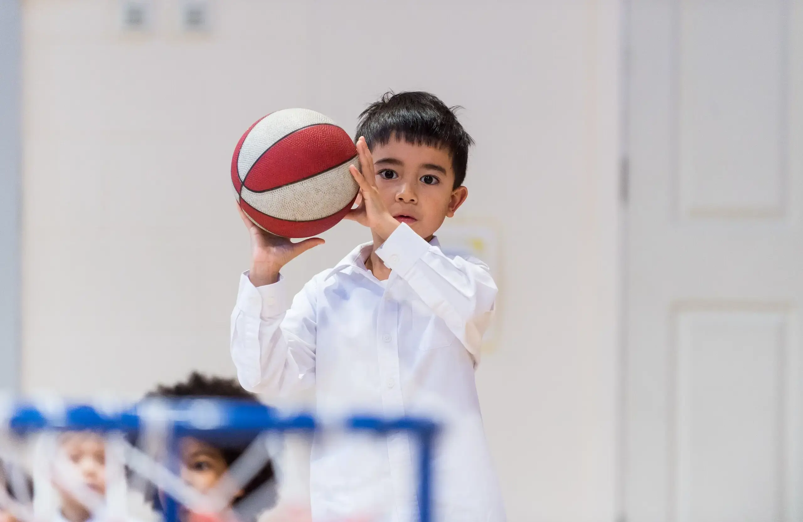 Student holding a basketball in both hands