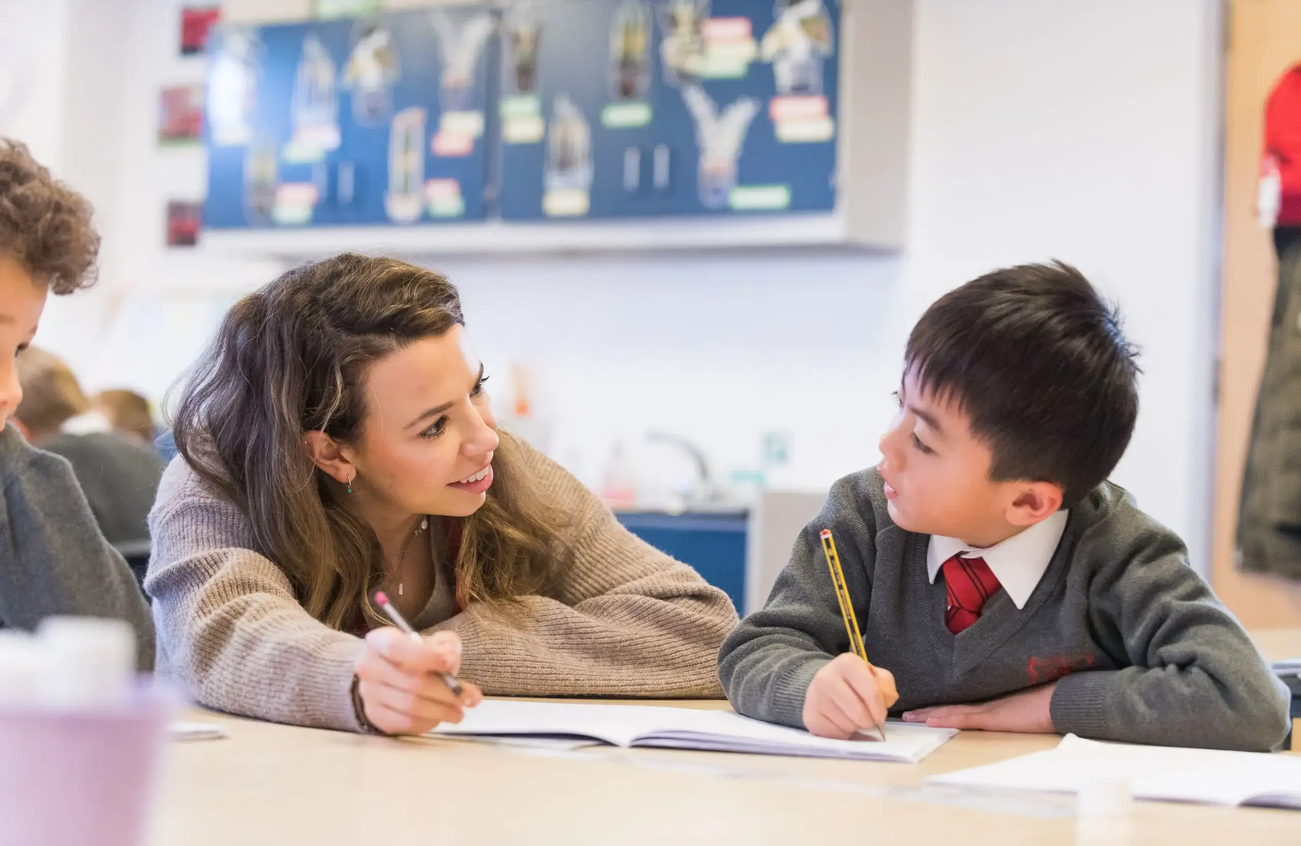 Teacher assisting student with studies