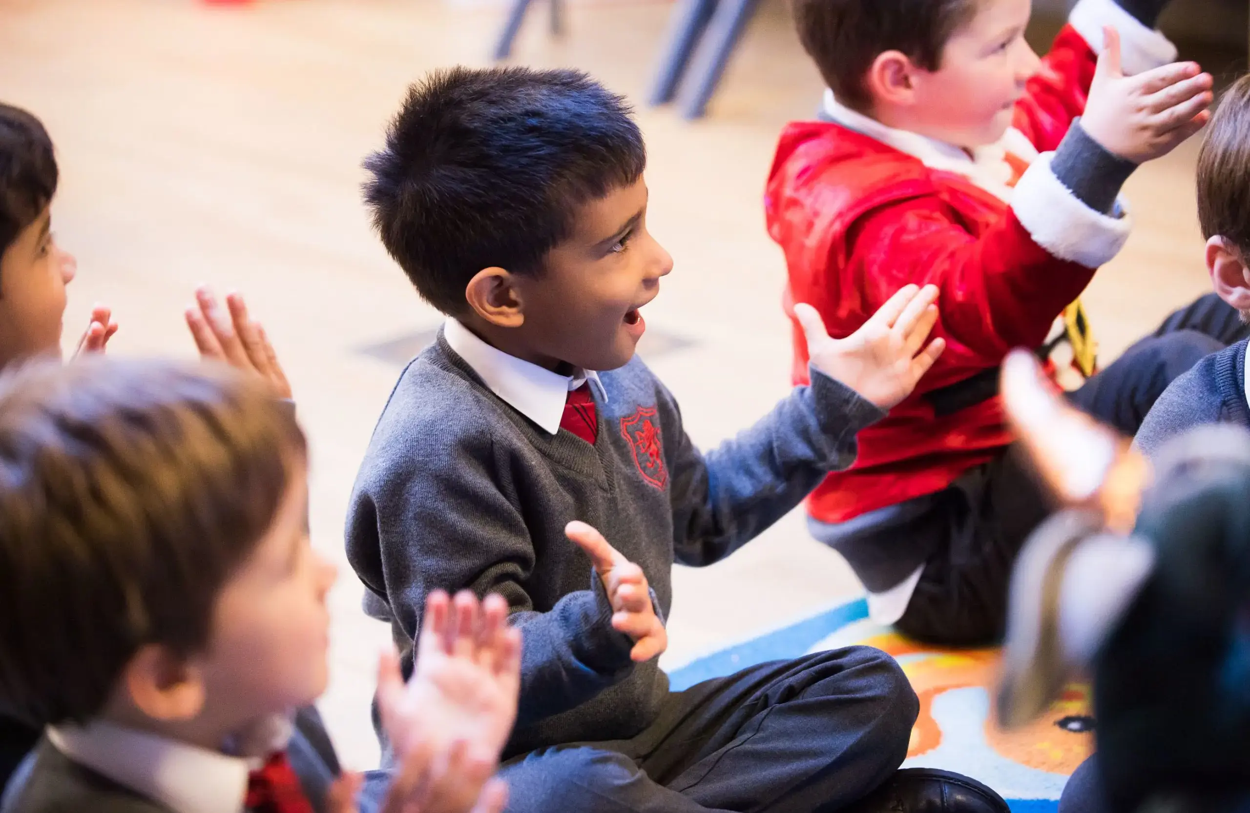 Students clapping together and smiling