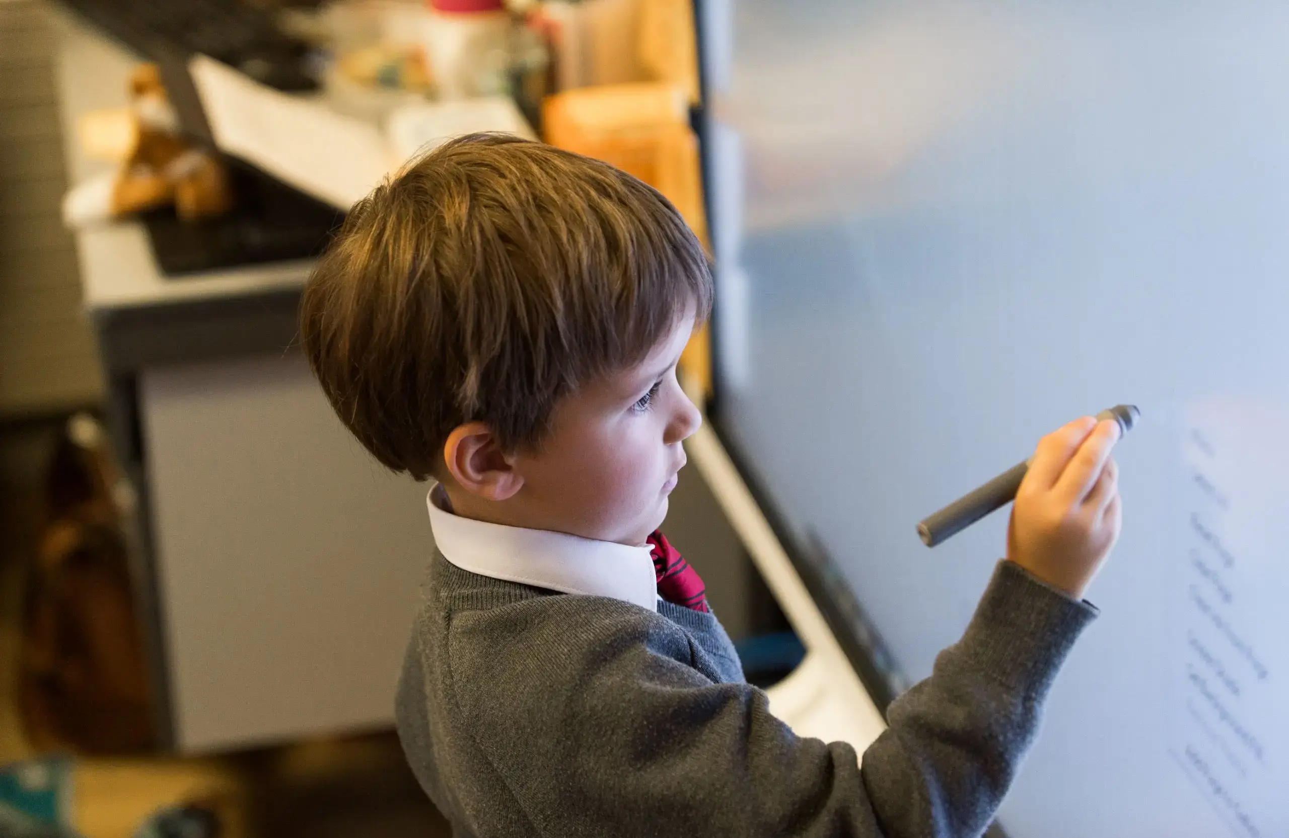 Student doing class work on white board
