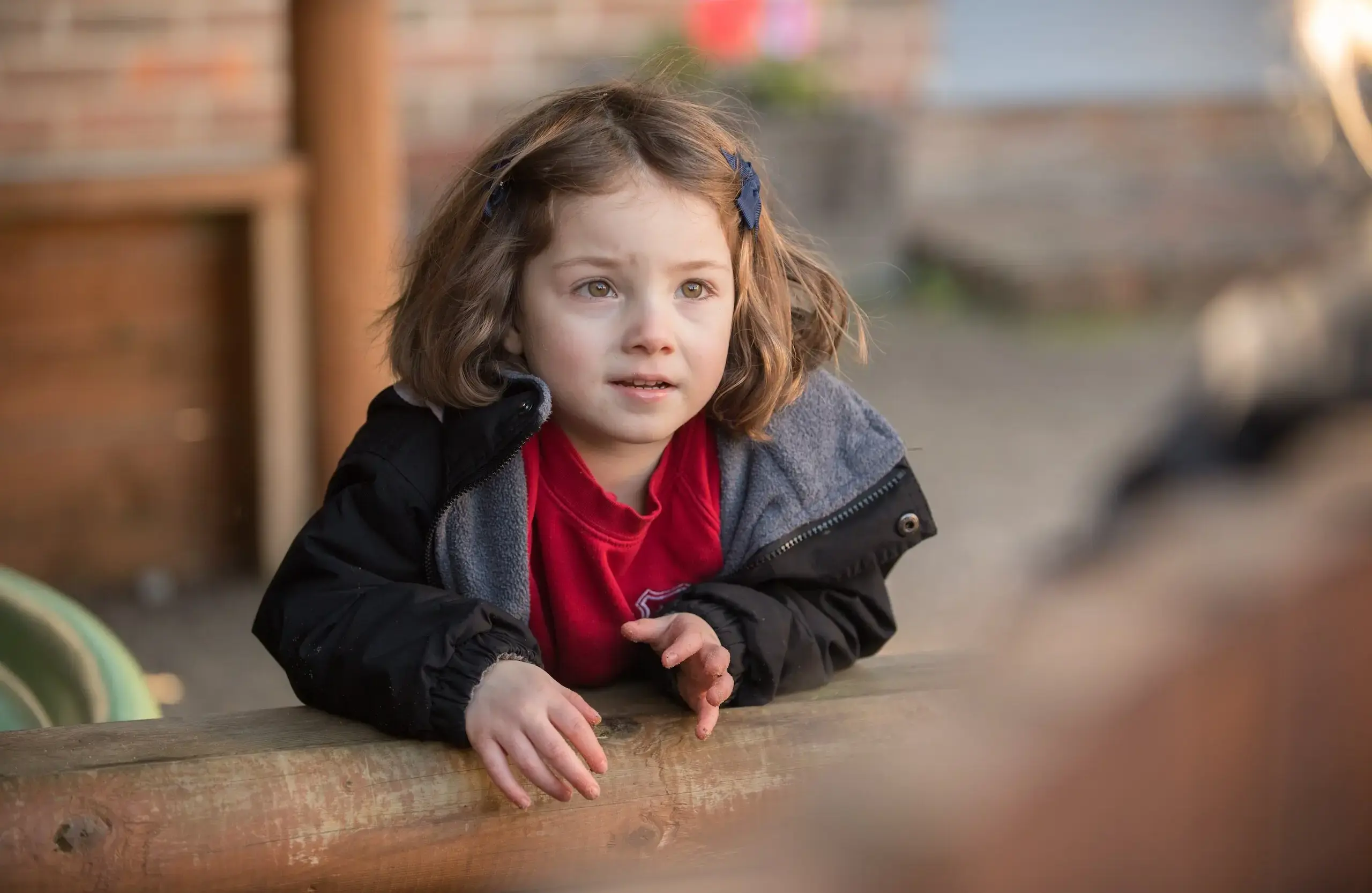Student leaning over a log