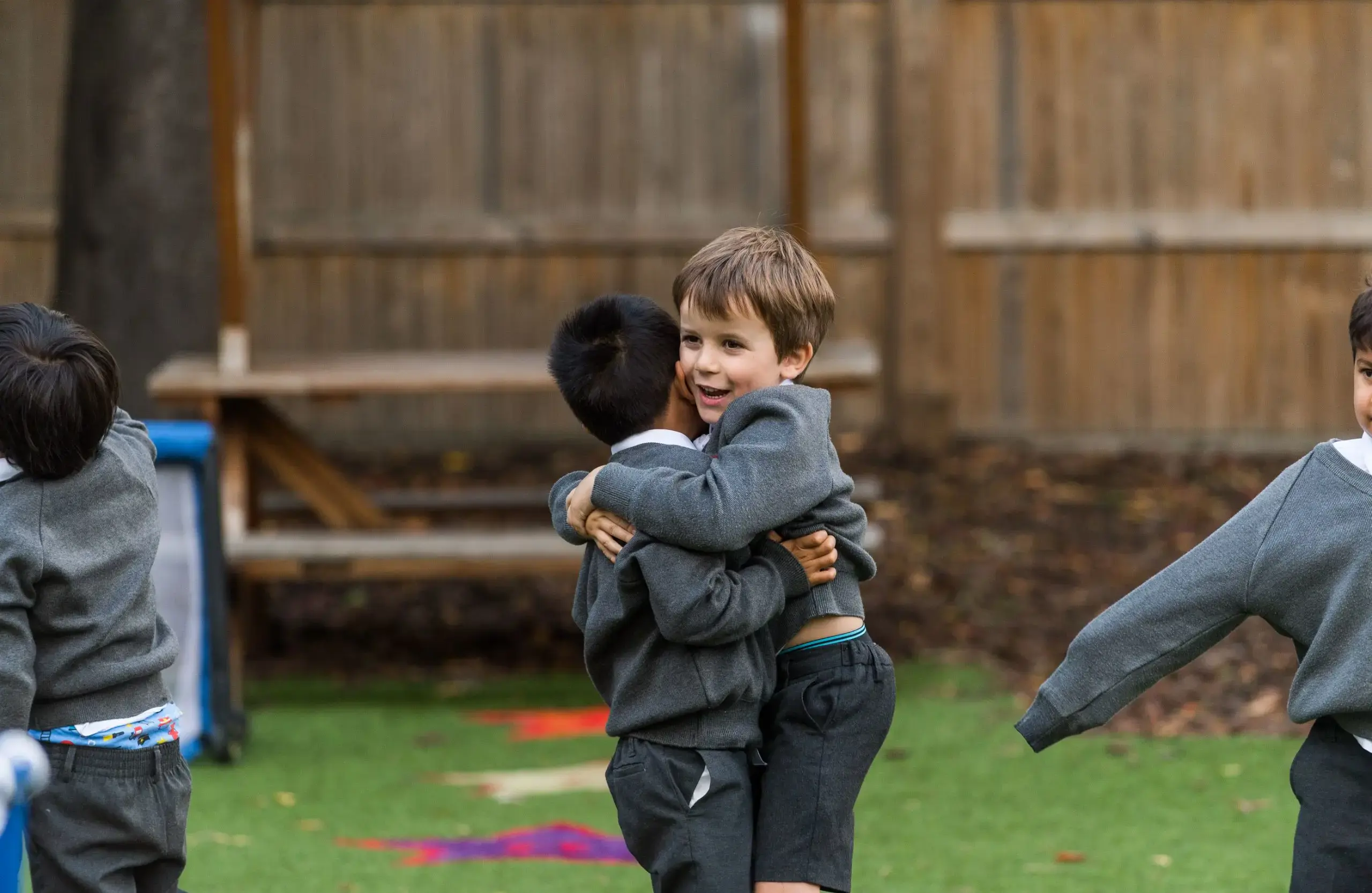 Shrewsbury House Pre-Prep students hugging in playground