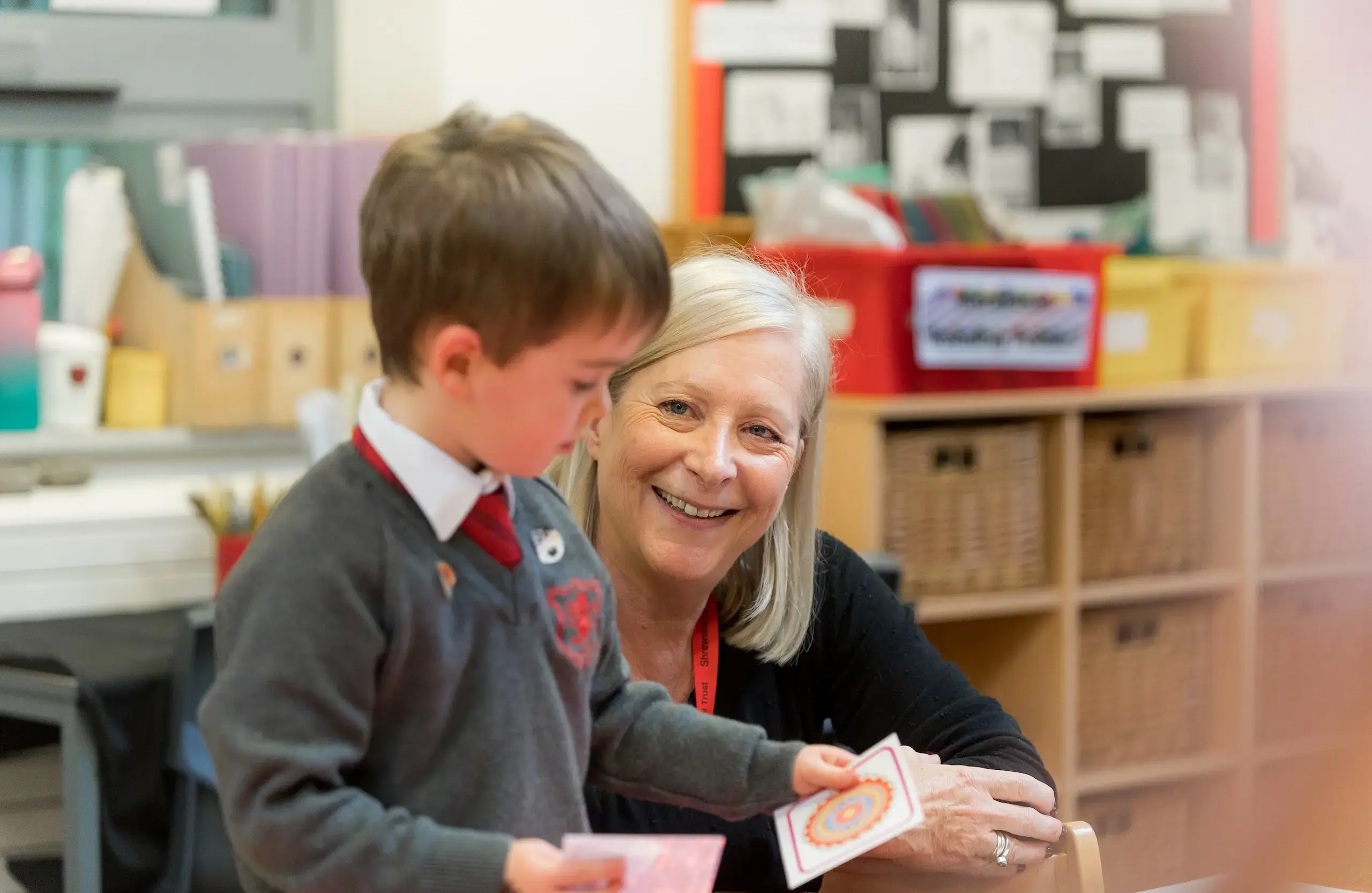 Teacher smiling up at student