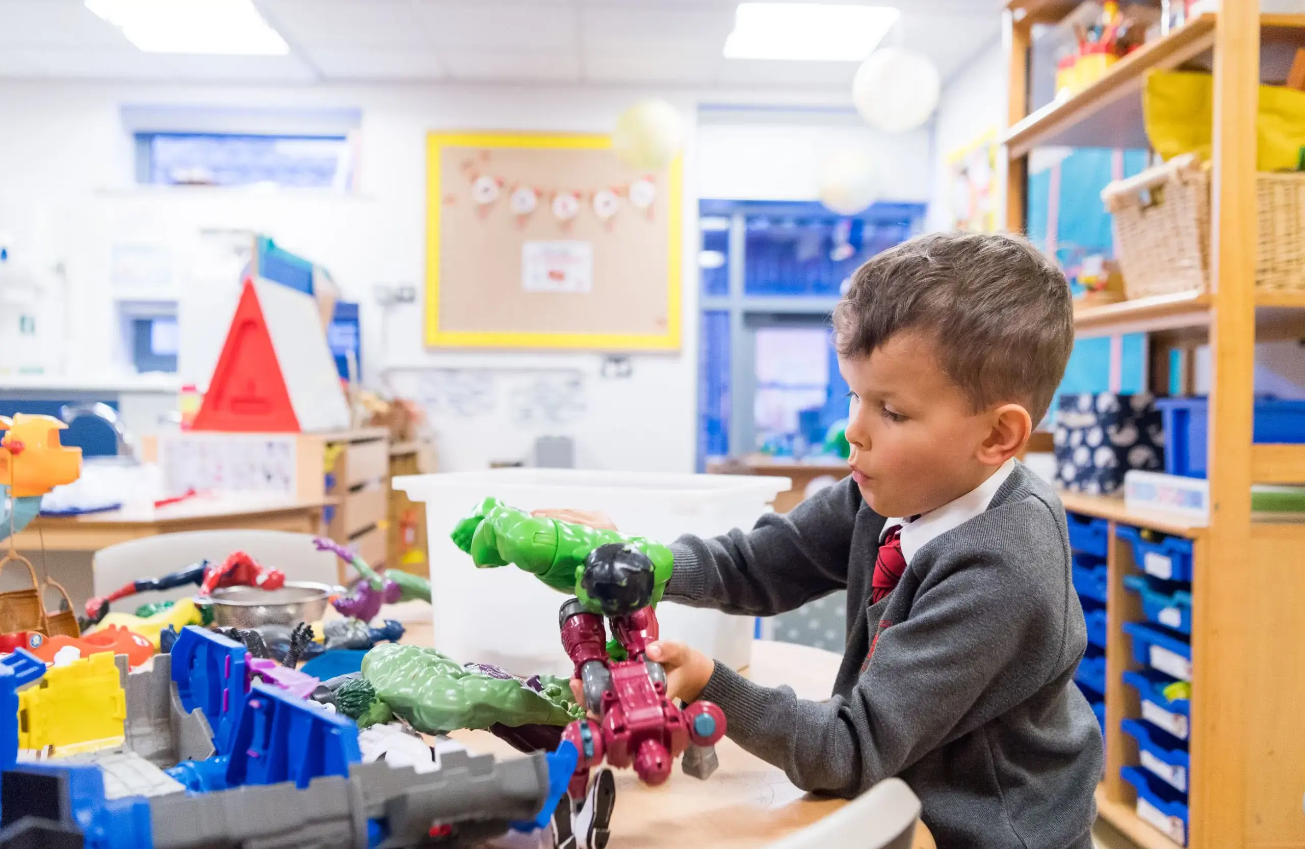 Student playing with toys in classroom