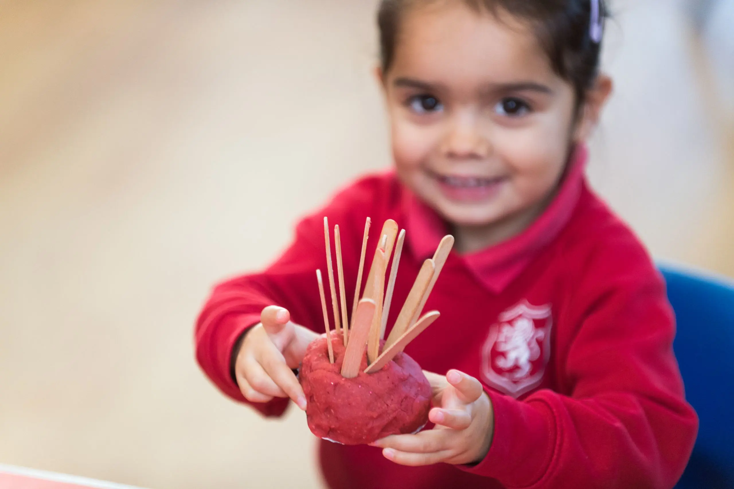 Shrewsbury House Pre-Prep Student making a craft and smiling