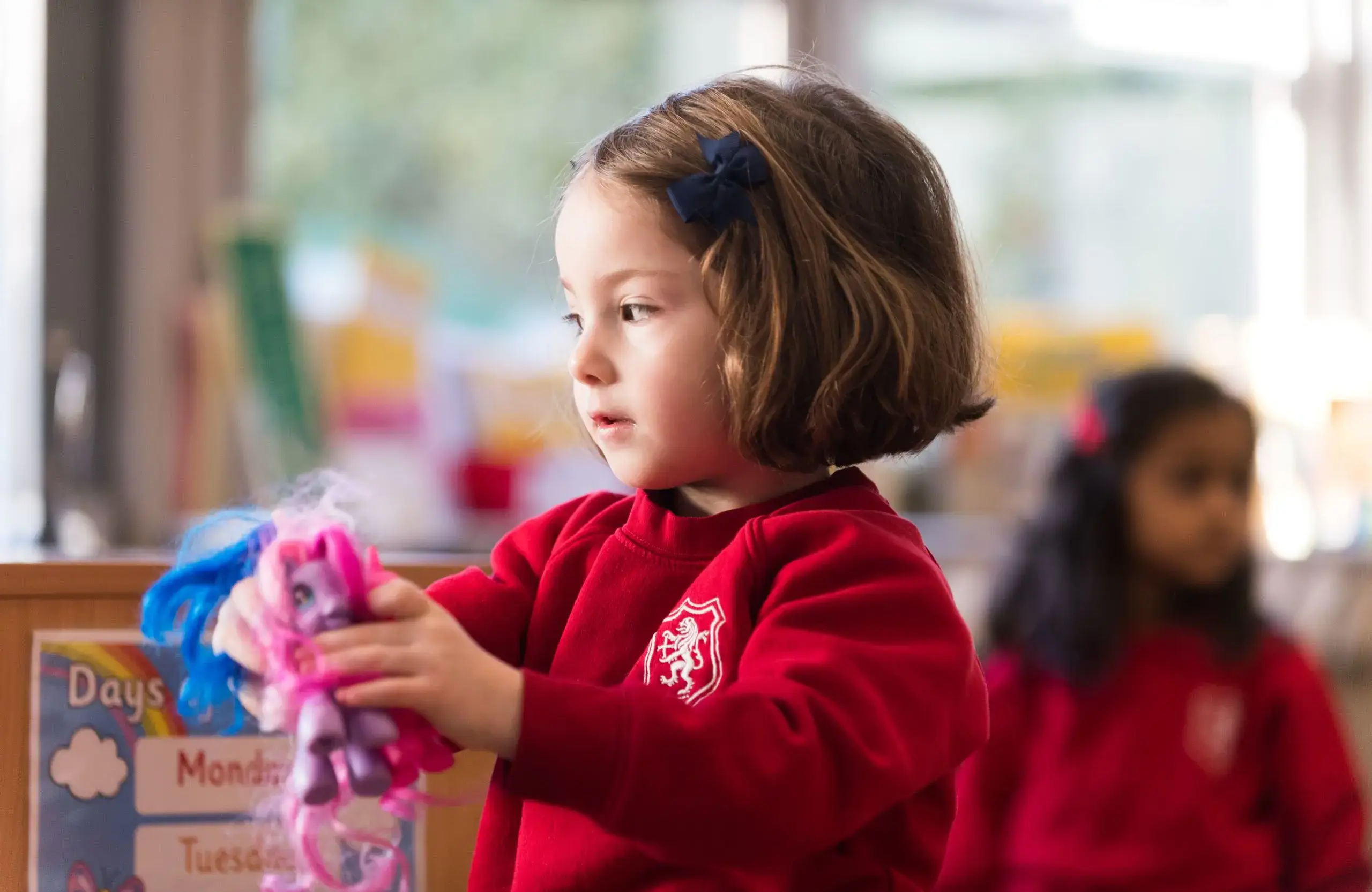 Student playing with toys in class