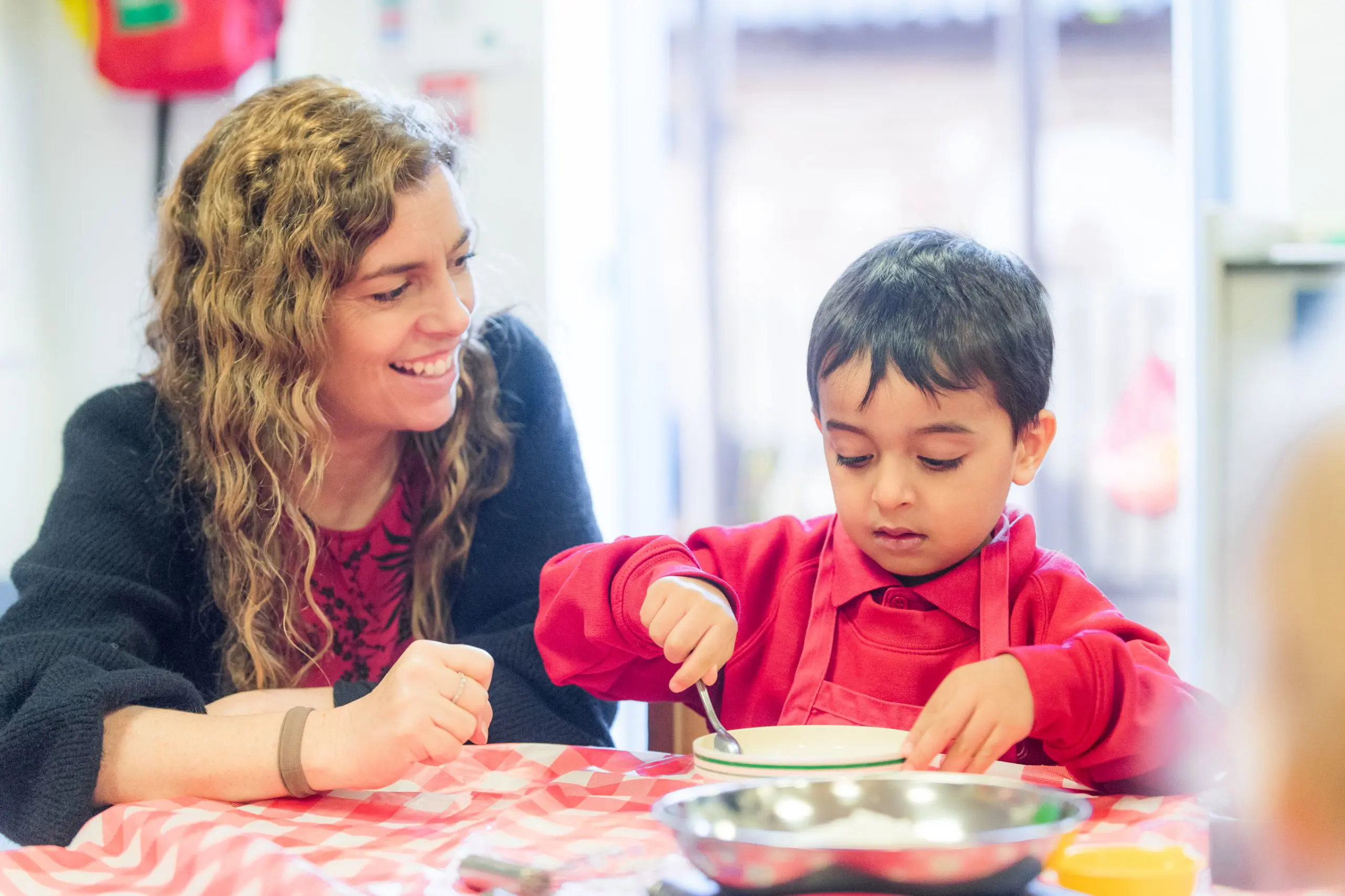 Shrewsbury House Pre-Prep Teacher playing with student while smiling