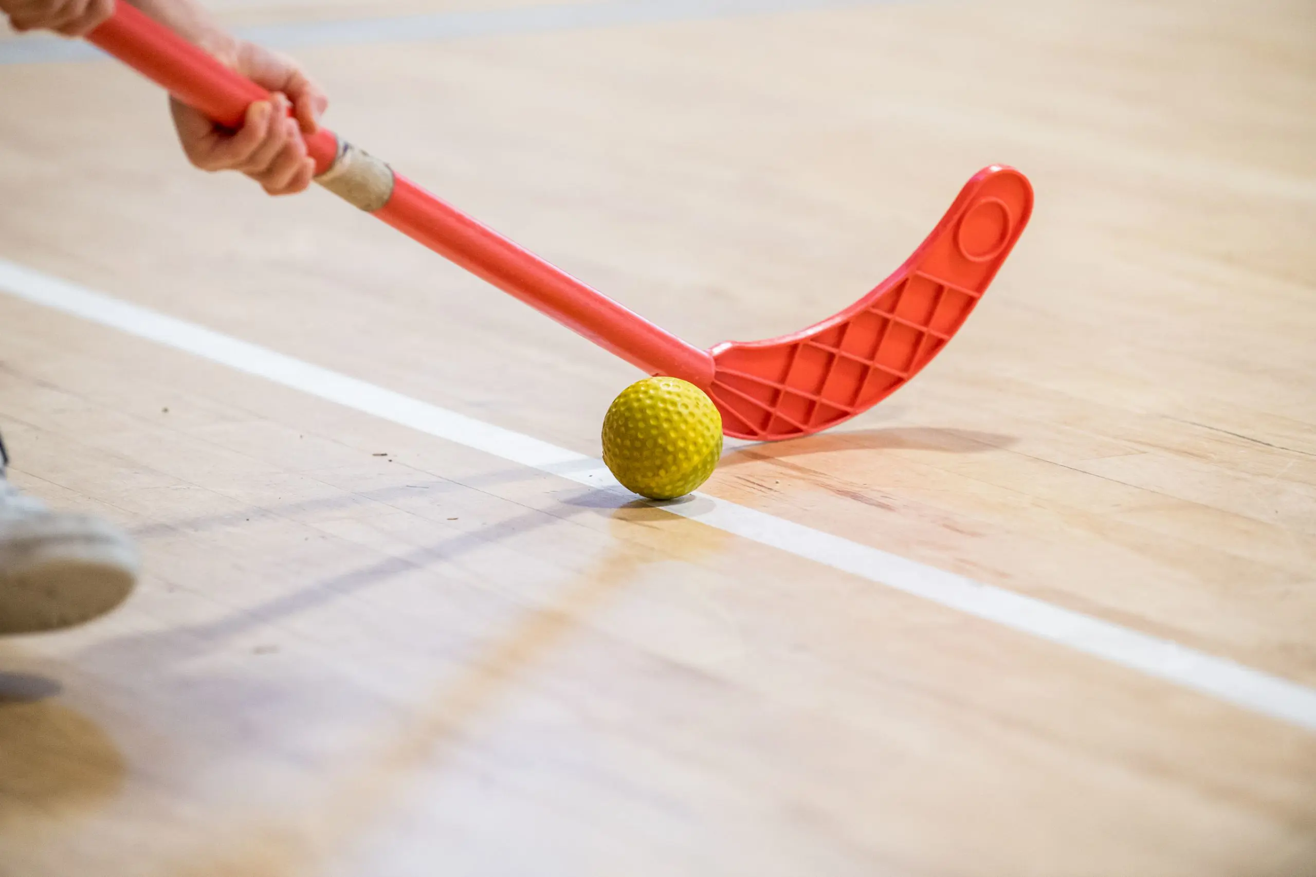 Students playing indoor hockey