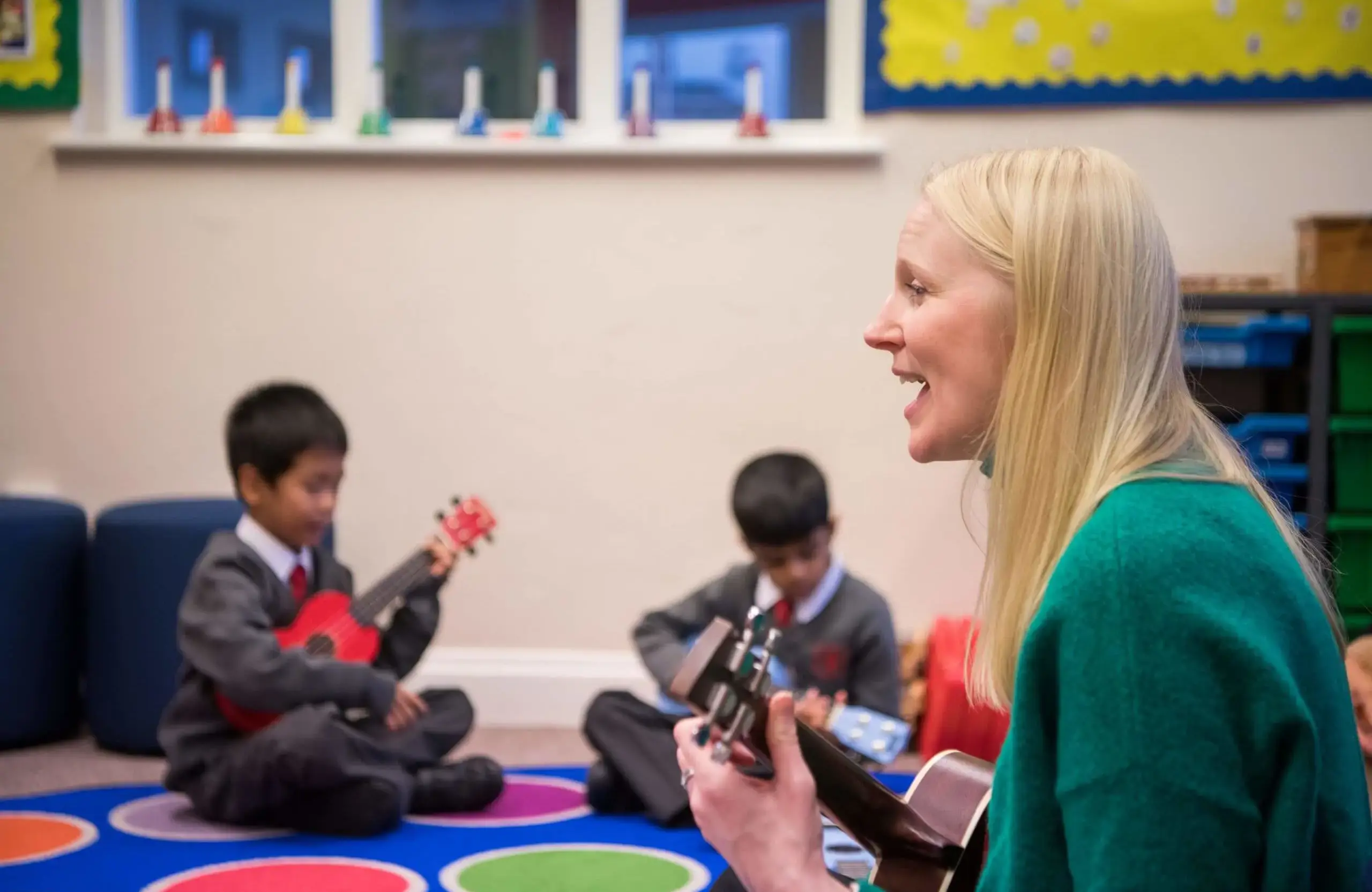 Shrewsbury House Pre-Prep students and teacher playing ukuleles.