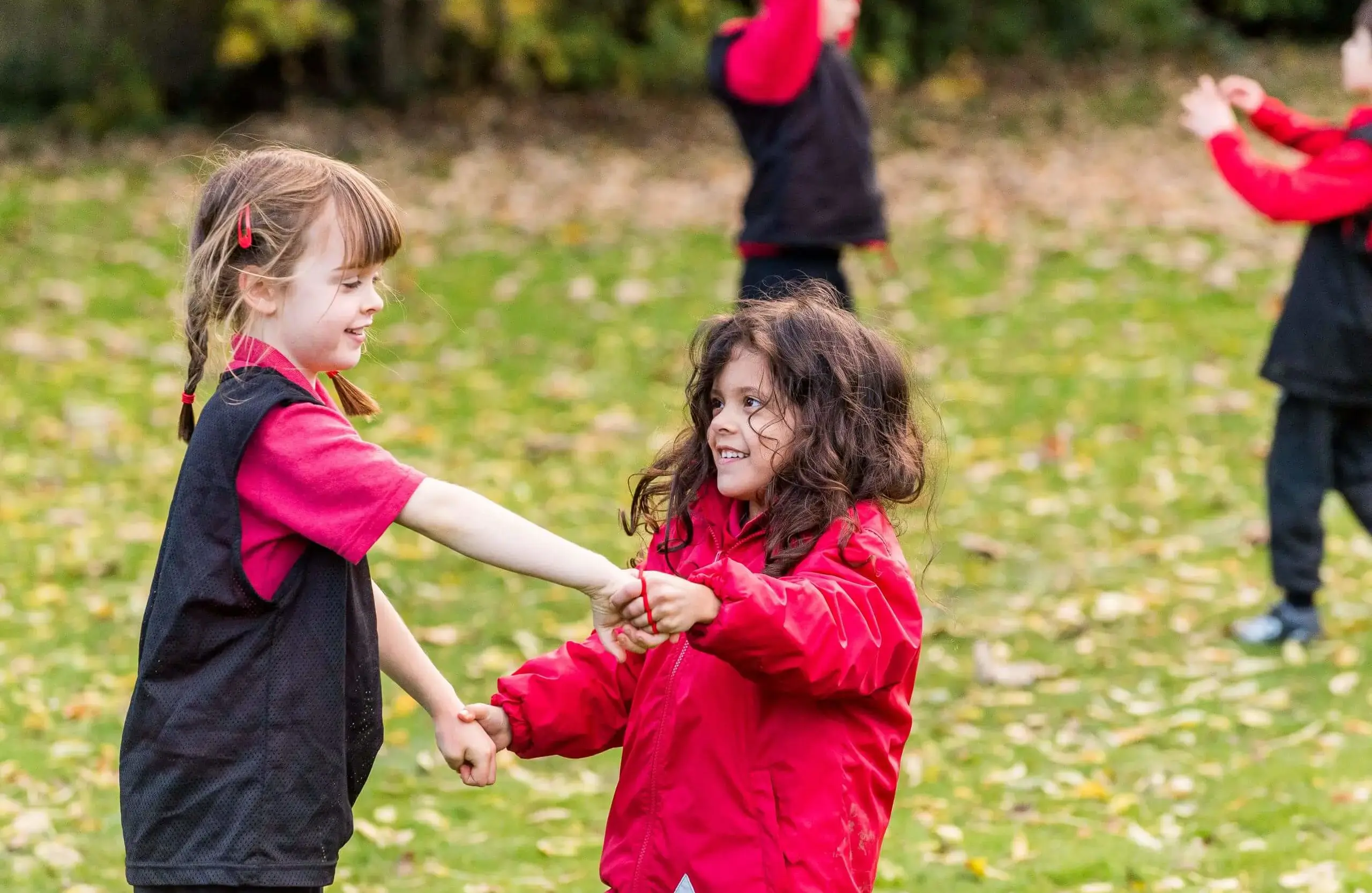 Shrewsbury House Pre-Prep students holding hands on the lawn