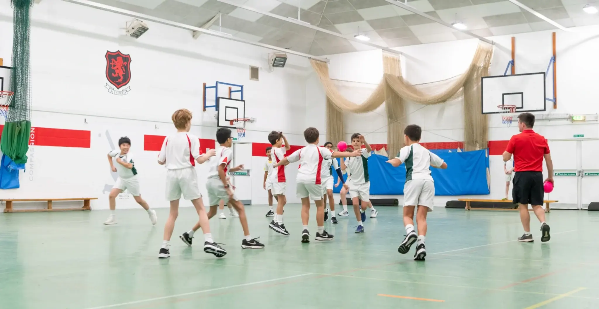 Students playing basketball indoors