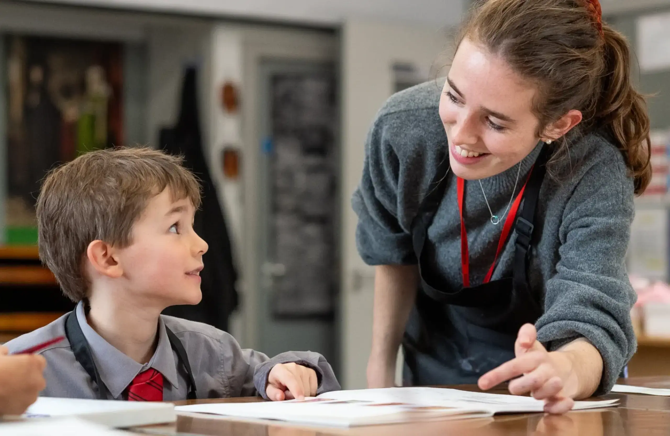 Teacher smiling at student