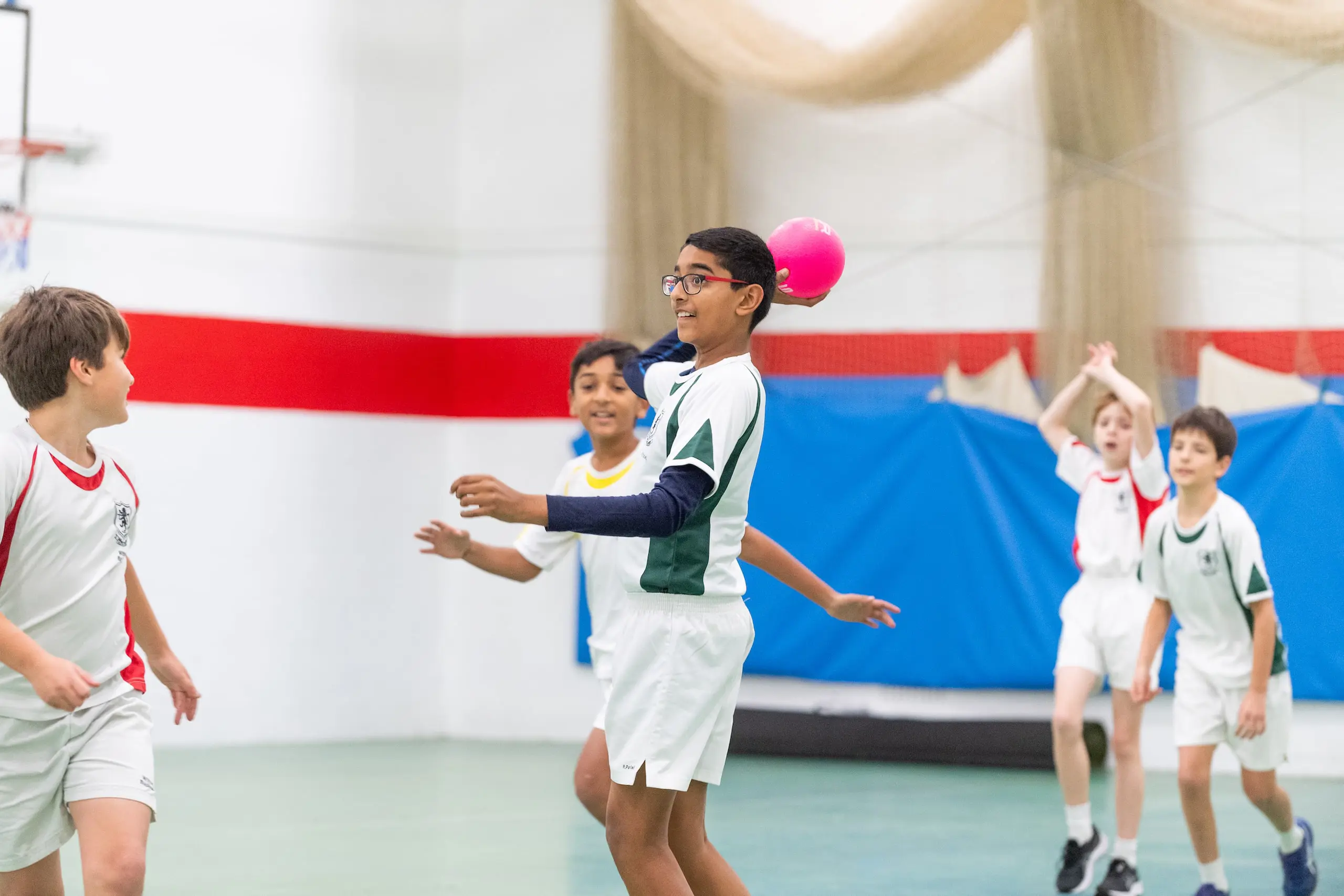 Students playing sports indoors