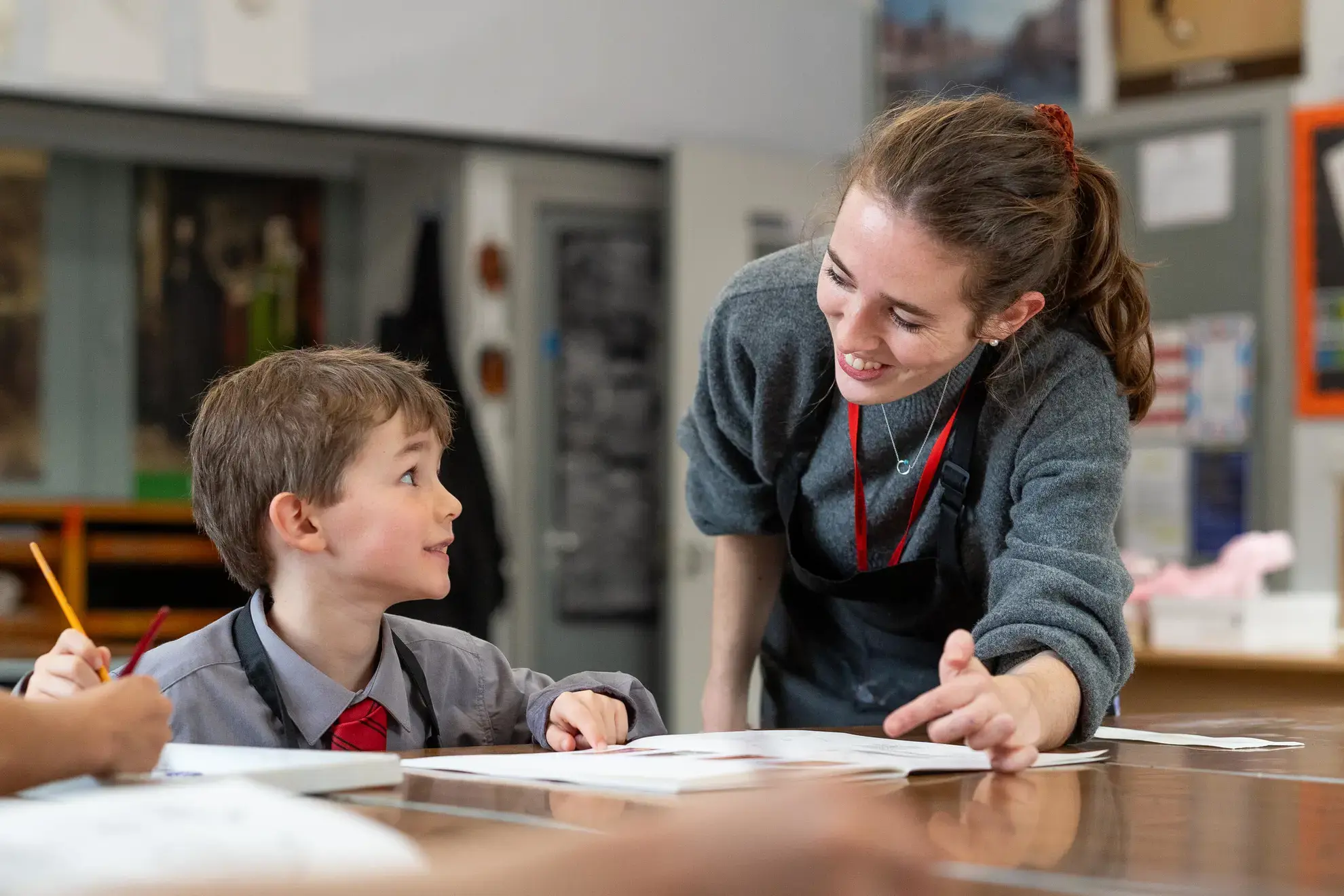 Teacher helping student in lesson