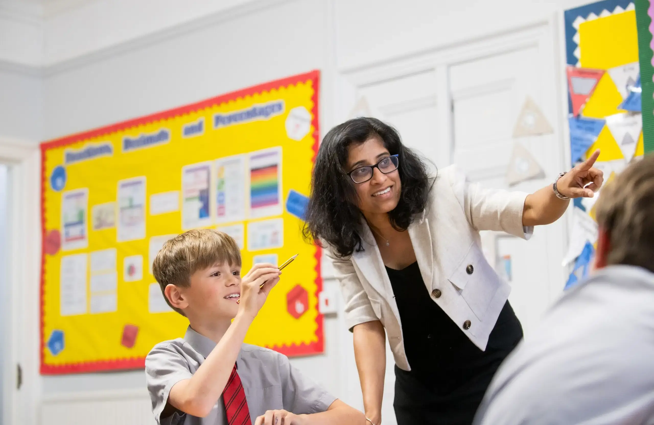 Teacher and student pointing together