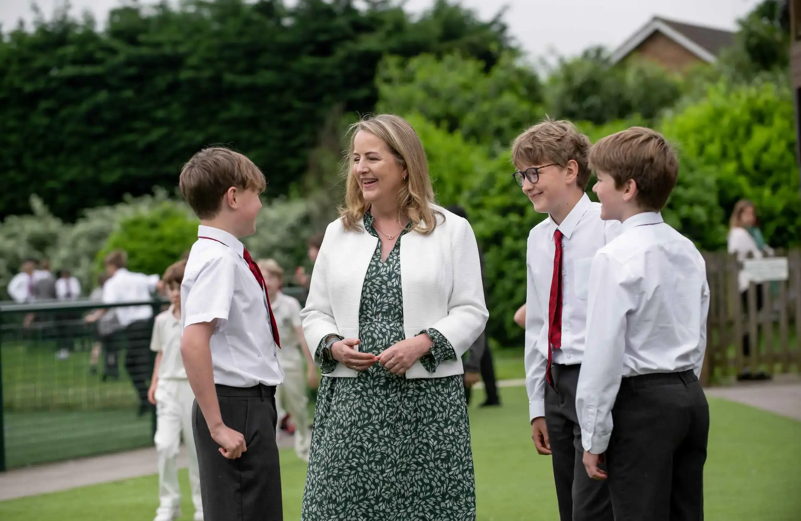 Teacher speaking with three students