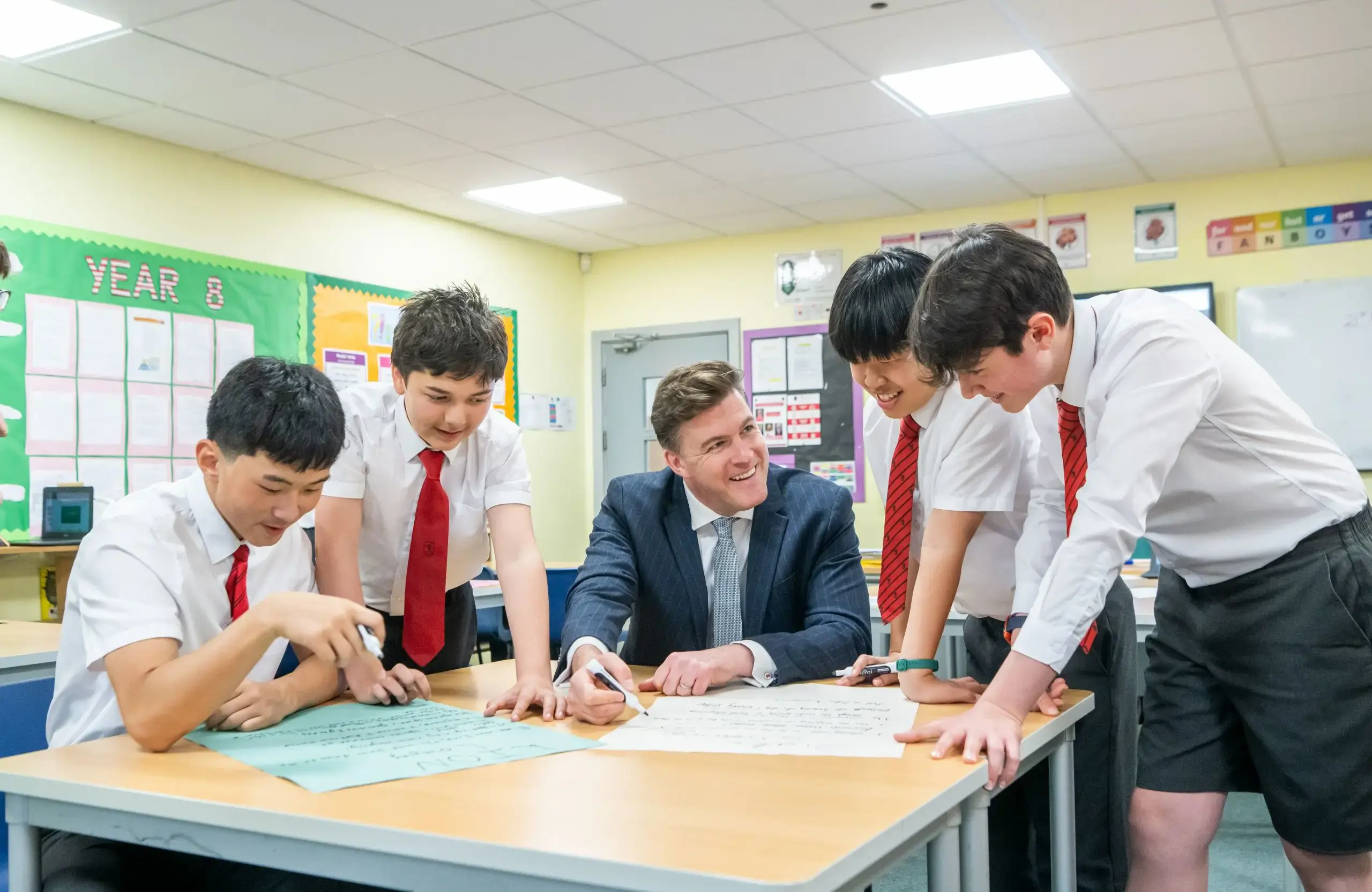 Students Studying with Teacher