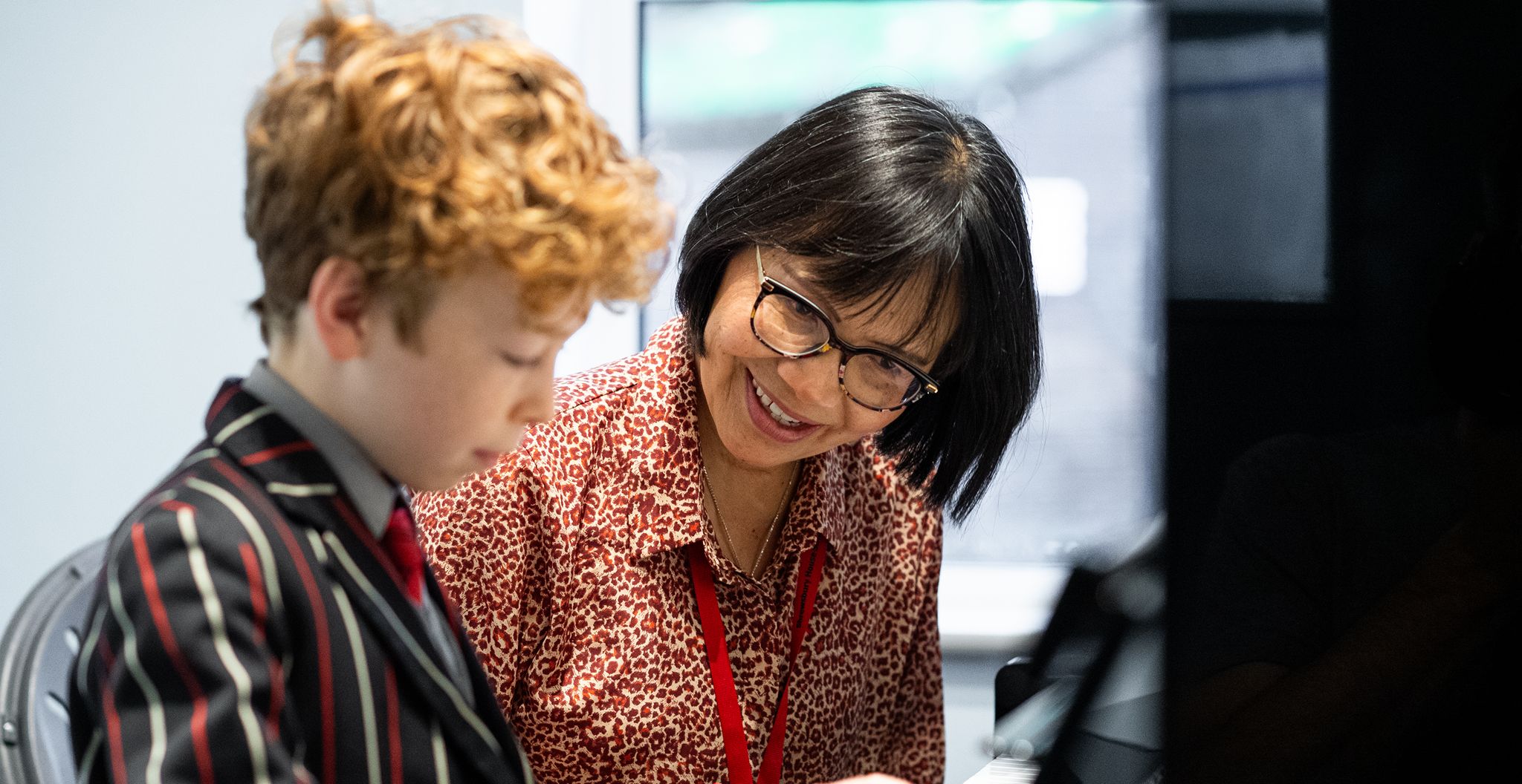 Teacher helping student with schoolwork