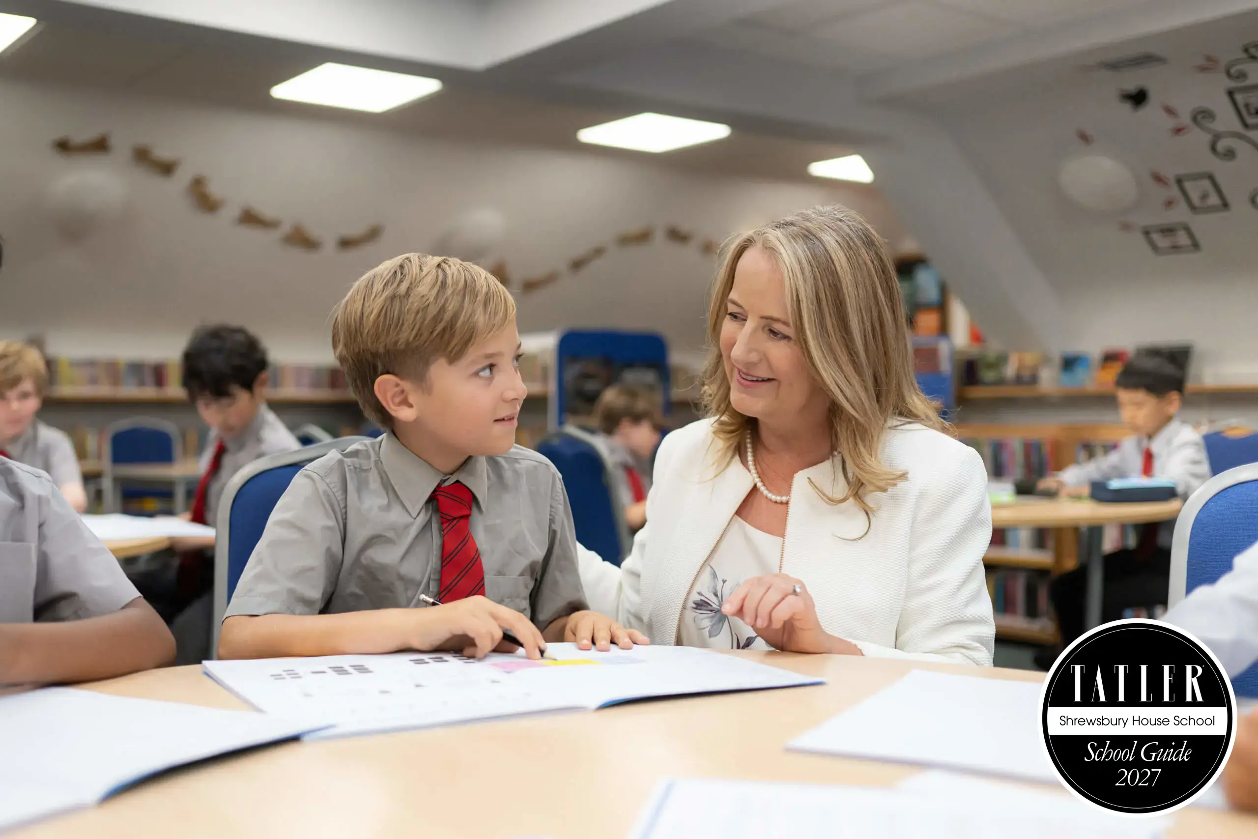Headteacher of top private school in Surrey with pupil, with Tatler School Guide 2027 seal.