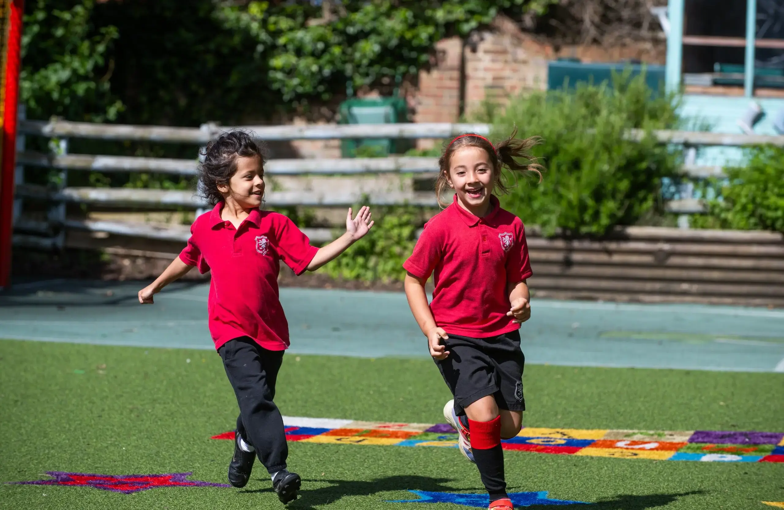 Students playing tag on an astroturf field