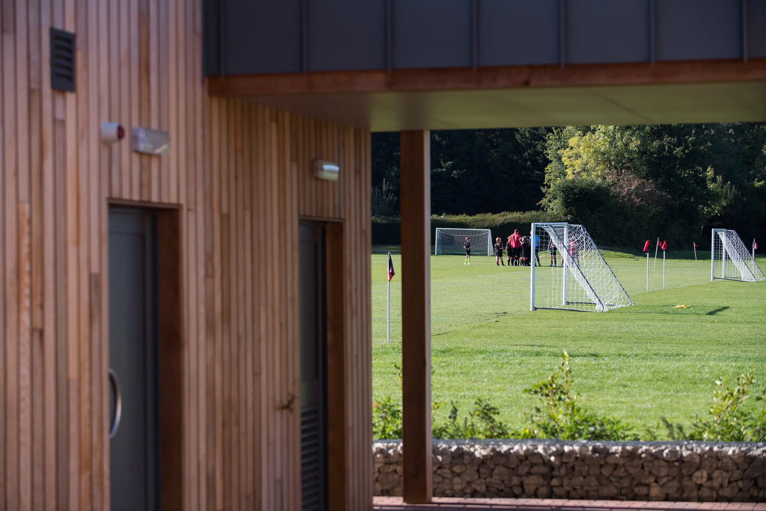Exterior of Shrewsbury House Sports Pavilion, football pitch in the background