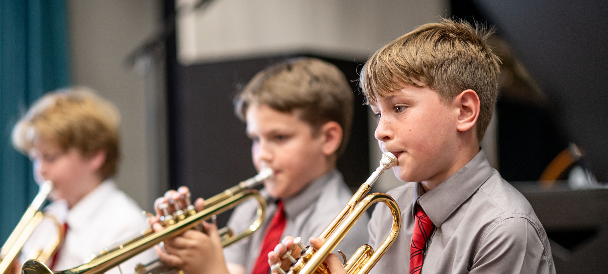 Three students playing musical instruments