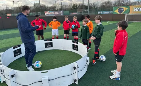 Coach talks to footballers