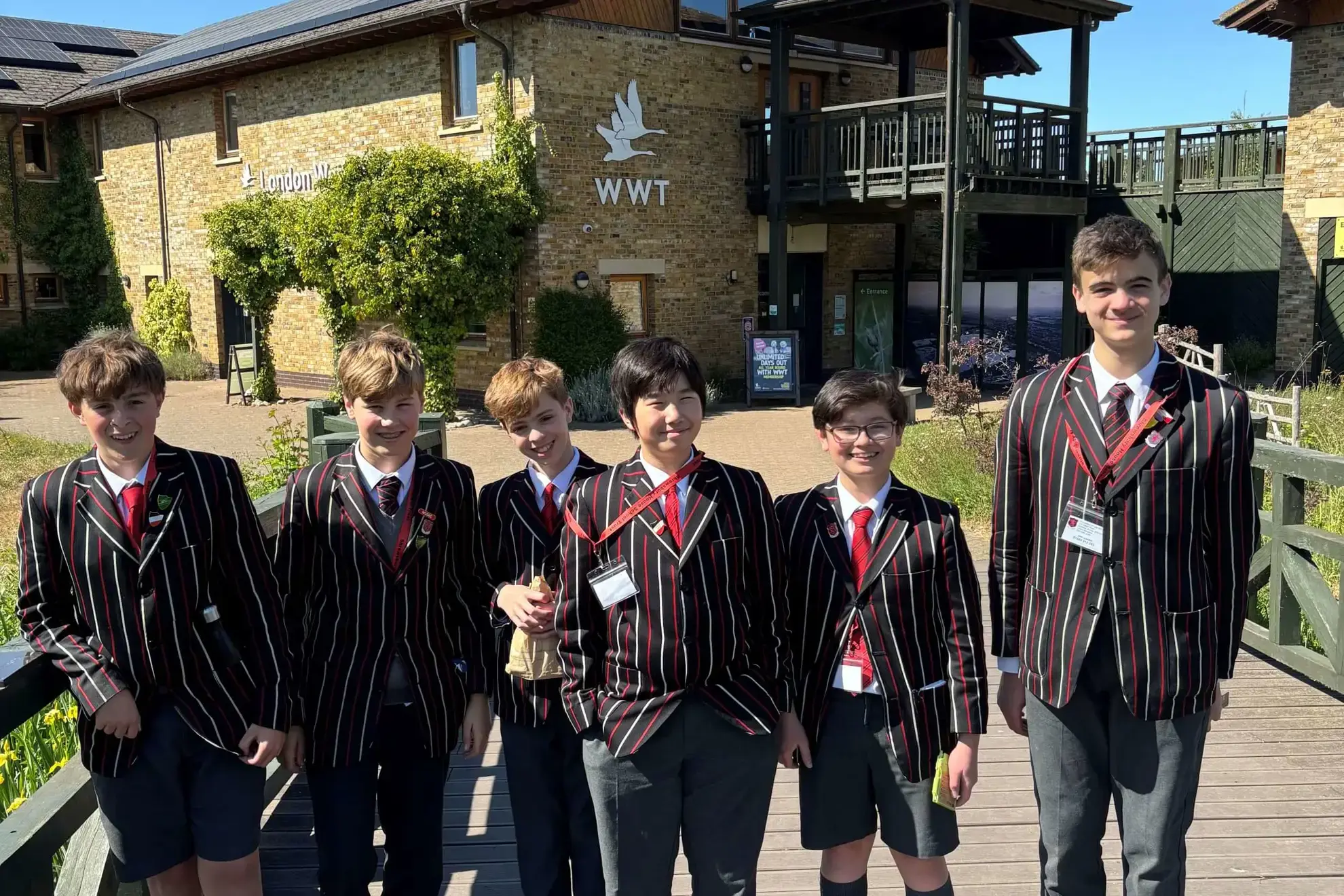 Group of students smiling outside the London WWT building